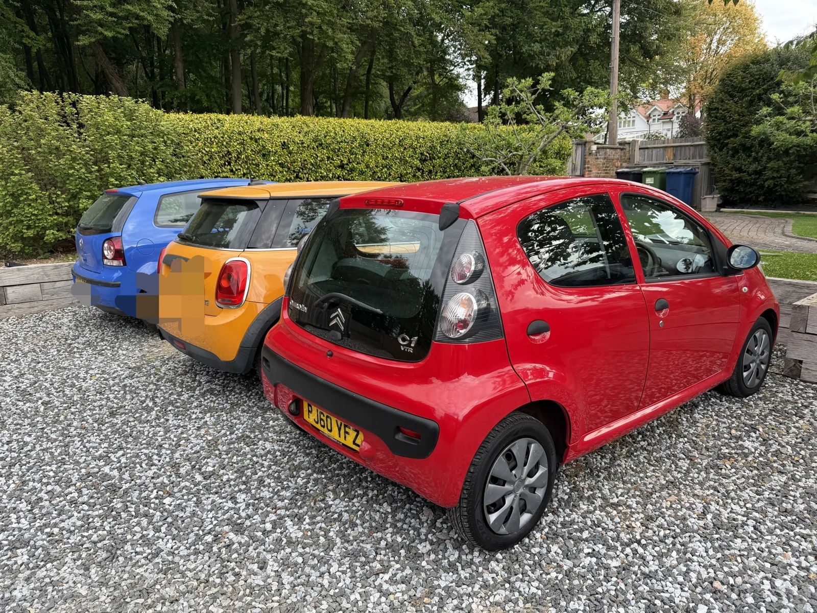 The original red five-door C1 parked on the driveway
